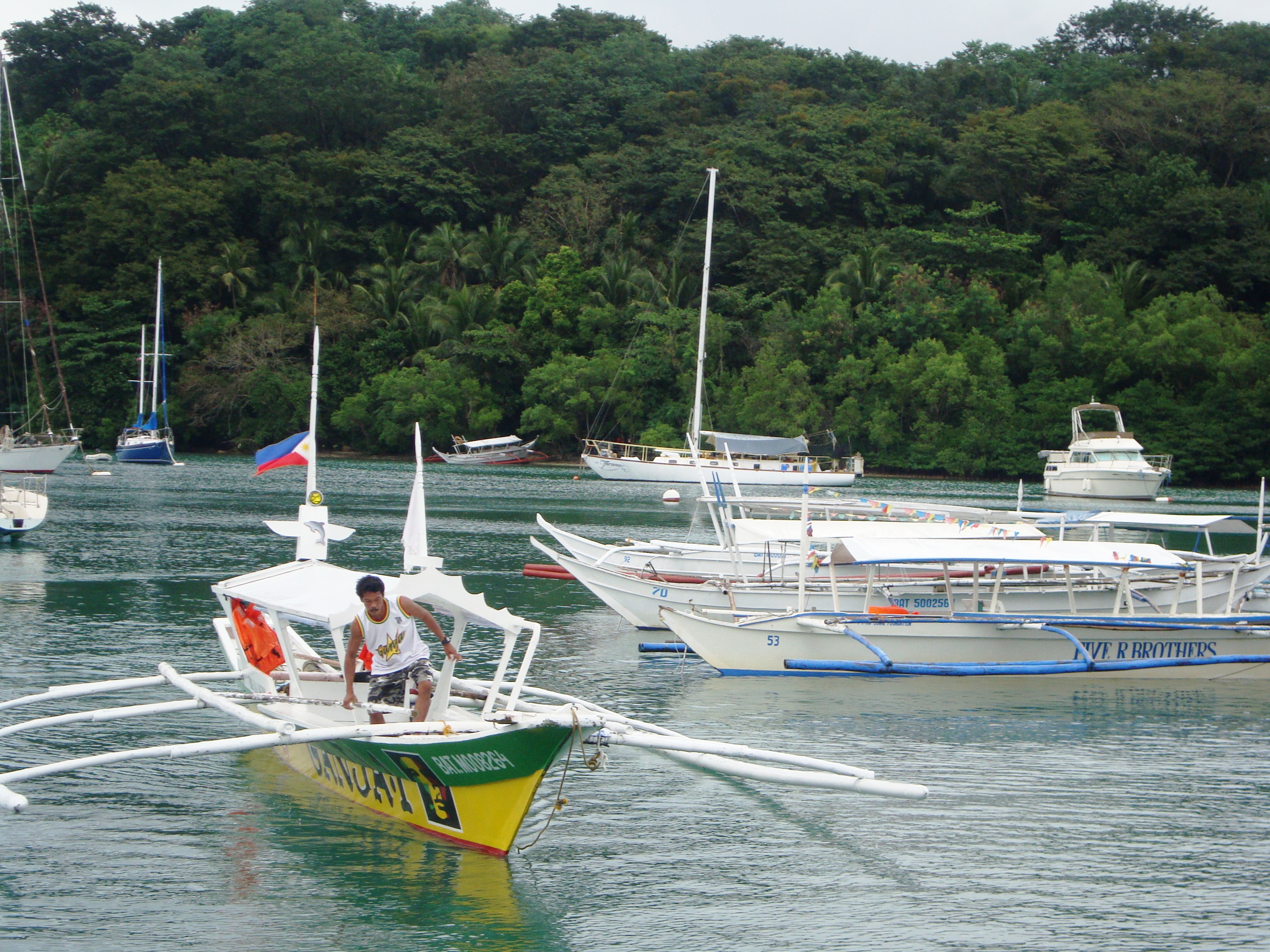 Traditional boats on the water in Puerto Galera